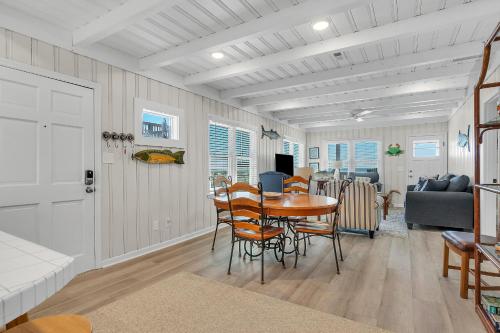 a dining room and living room with a table and chairs at Lowe Tide by Oak Island Accommodations in Oak Island