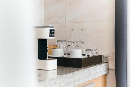 a kitchen with a counter with a coffee machine at Sé Boutique Hotel in Funchal