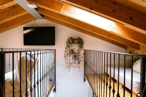 a room with a staircase with a flat screen tv at Venice's neighbor Home in Mirano