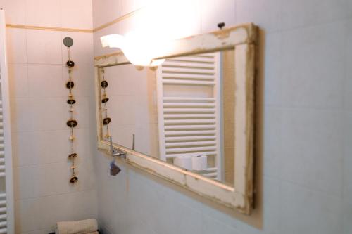 a mirror in a bathroom with a window at Venice's neighbor Home in Mirano