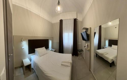 a bedroom with two beds and a television in it at Hotel Bogart Milano in Milan