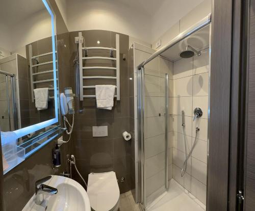 a bathroom with a shower and a toilet and a sink at Hotel Bogart Milano in Milan
