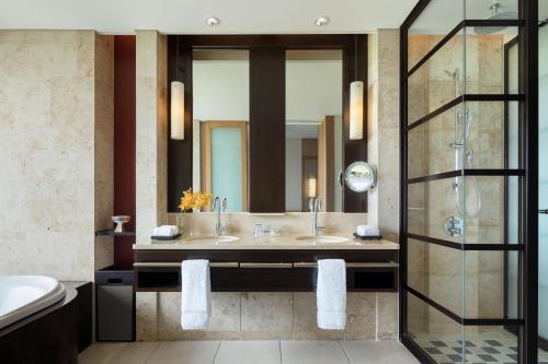 a bathroom with two sinks and a shower at The Ritz-Carlton Okinawa in Nago