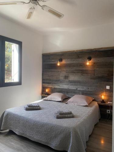 une chambre avec un grand lit avec deux serviettes dessus dans l'établissement ALICIA, à Zonza