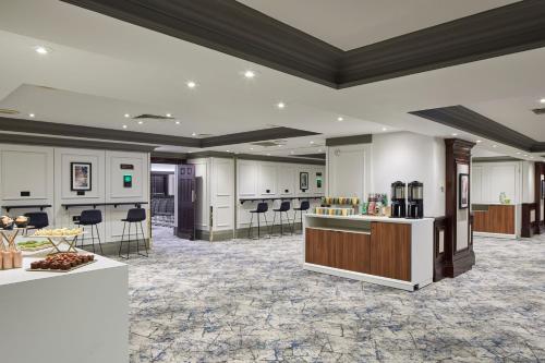 a large lobby with a hair salon with chairs at Leeds Marriott Hotel in Leeds
