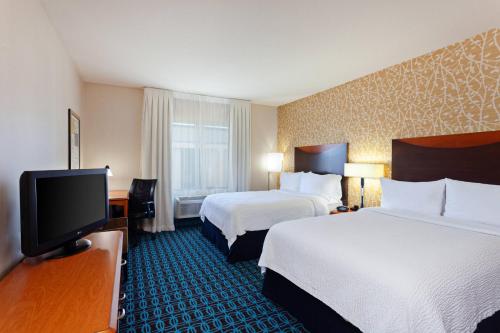 a hotel room with two beds and a flat screen tv at Fairfield Inn & Suites - Los Angeles West Covina in West Covina