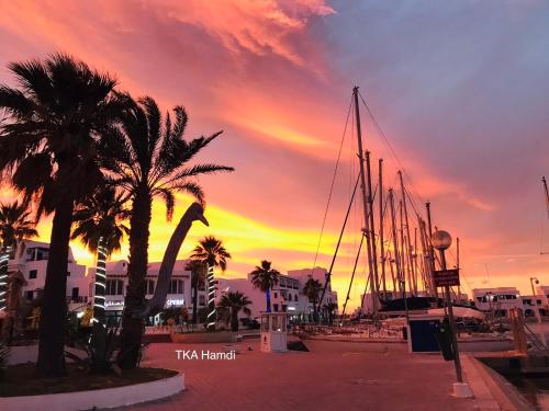 a group of boats parked in a marina at sunset at Private Apartment at Marina Monastir in Monastir