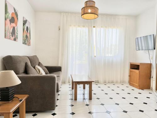 a living room with a couch and a table at Albir Hills Apartments in Albir