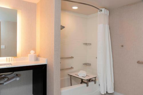 a bathroom with a shower and a sink and a tub at Residence Inn by Marriott Lafayette in Lafayette