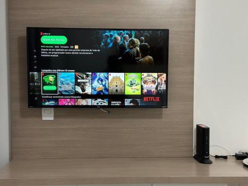 a flat screen tv hanging on a wall at Refúgio Beira Lago- Life Resort in Brasilia
