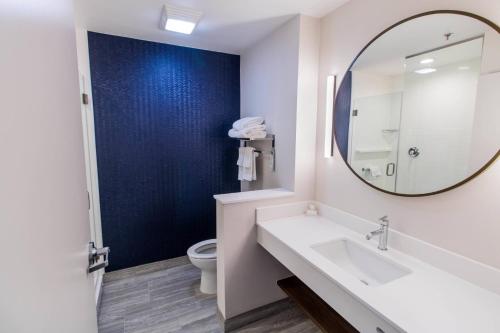 a bathroom with a sink and a mirror and a toilet at Fairfield Inn & Suites by Marriott Brownsville North in Brownsville