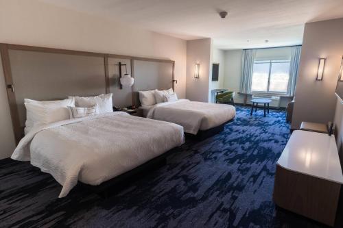 a hotel room with two beds and a window at Fairfield Inn & Suites by Marriott Brownsville North in Brownsville