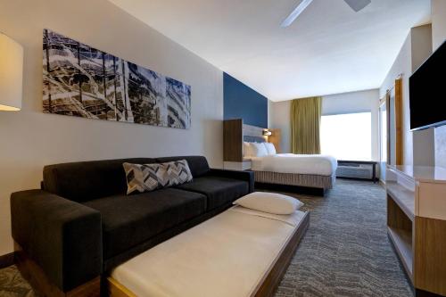 a living room with a couch and a bed at SpringHill Suites by Marriott Las Cruces in Las Cruces