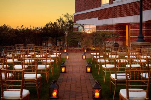 a row of chairs with candles in front of a building at Marriott Boston Quincy in Quincy