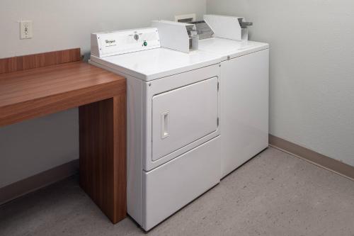 a white washer and dryer sitting next to a desk at Fairfield Inn and Suites by Marriott Lake Charles - Sulphur in Sulphur