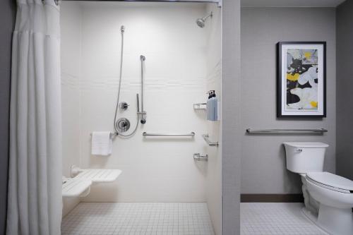 a white bathroom with a toilet and a shower at Residence Inn by Marriott Dallas Downtown in Dallas