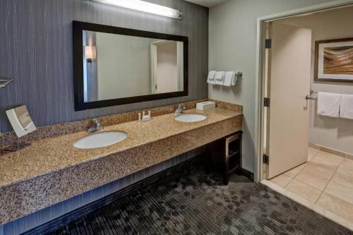 a hotel bathroom with two sinks and a mirror at Courtyard by Marriott Troy in Troy