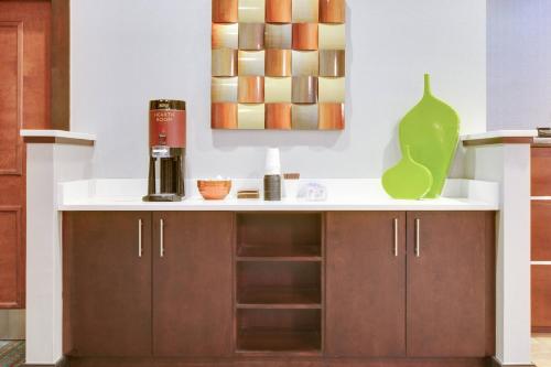 a kitchen with a white counter and a green vase at Residence Inn Midland in Midland