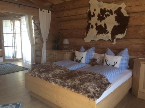 a bedroom with a bed in a log cabin at Holzberghof in Umhausen