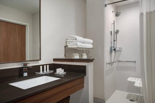 a bathroom with a sink and a shower at Fairfield Inn & Suites by Marriott Milwaukee West in West Milwaukee