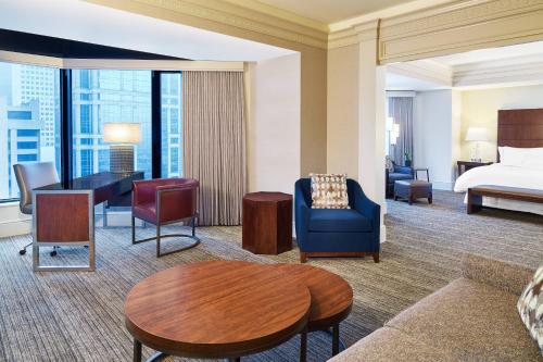 a hotel room with a king bed and a living room at The Westin Chicago River North in Chicago