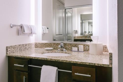 a bathroom with a sink and a mirror at Residence Inn by Marriott Lincoln South in Lincoln