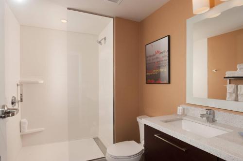 a bathroom with a shower and a toilet and a sink at TownePlace Suites by Marriott Charleston Airport/Convention Center in Charleston