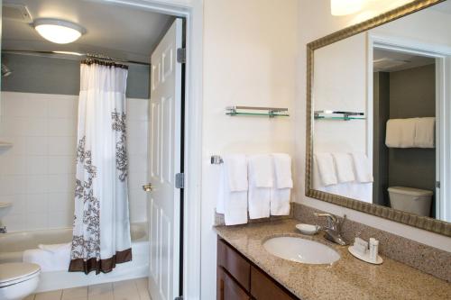 a bathroom with a sink and a mirror at Residence Inn Arundel Mills BWI Airport in Hanover