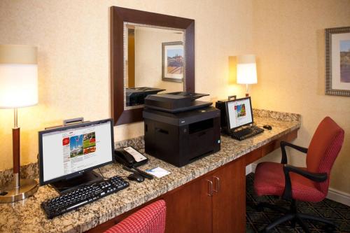 a hotel room with a desk with a computer and a monitor at Residence Inn Arundel Mills BWI Airport in Hanover