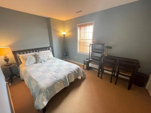 a bedroom with a bed and a desk and a window at Luxury Downtown Living In Armory Square in Syracuse