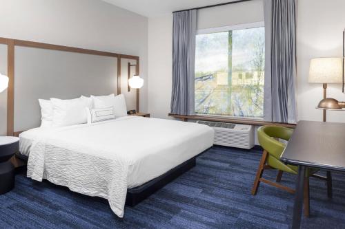 a hotel room with a bed and a window at Fairfield Inn & Suites by Marriott Fort Collins South in Fort Collins