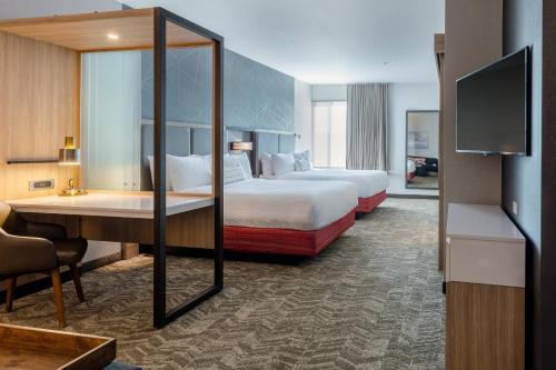 a hotel room with two beds and a desk at SpringHill Suites by Marriott Columbia in Columbia