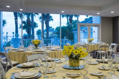 a dining room with tables and chairs with yellow flowers at Clearwater Beach Marriott Resort on Sand Key in Clearwater Beach