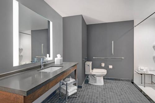 a bathroom with a sink and a toilet at Courtyard by Marriott Manhattan Aggieville in Manhattan