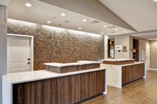 a lobby with a counter and a tile wall at Residence Inn by Marriott Cleveland Airport/Middleburg Heights in Middleburg Heights