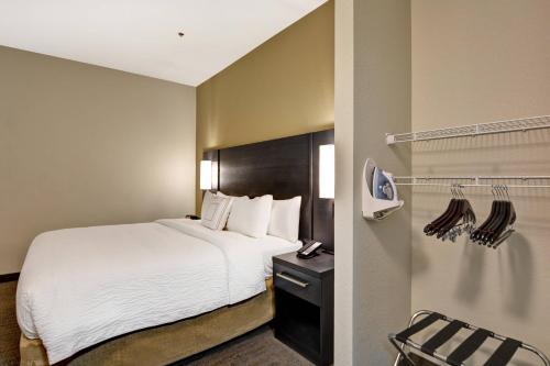 a hotel room with a bed and a closet at Residence Inn by Marriott Cleveland Airport/Middleburg Heights in Middleburg Heights