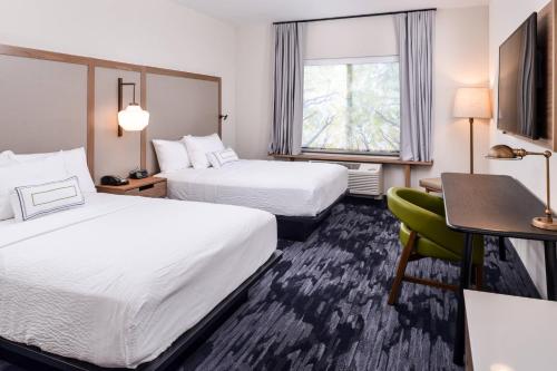 a hotel room with two beds and a desk and a chair at Fairfield Inn & Suites by Marriott Staunton in Staunton