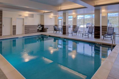 a swimming pool with blue water in a building at Fairfield Inn & Suites by Marriott Staunton in Staunton