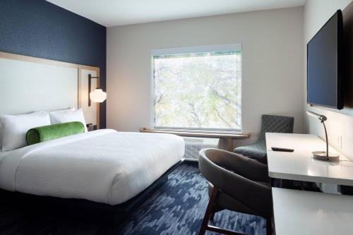 a hotel room with a bed and a window at Fairfield Inn & Suites by Marriott Wellington-West Palm Beach in Wellington