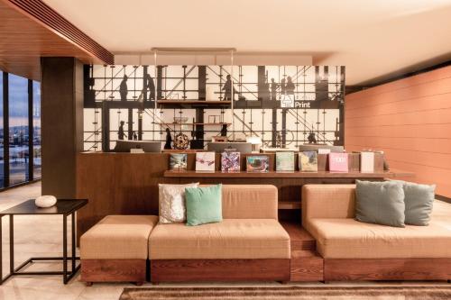 a lobby with two benches in front of a store at Courtyard by Marriott Mexico City Vallejo in Mexico City