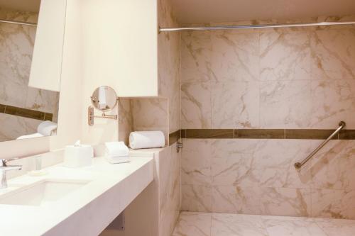 a bathroom with a sink and a shower at Courtyard by Marriott Mexico City Vallejo in Mexico City