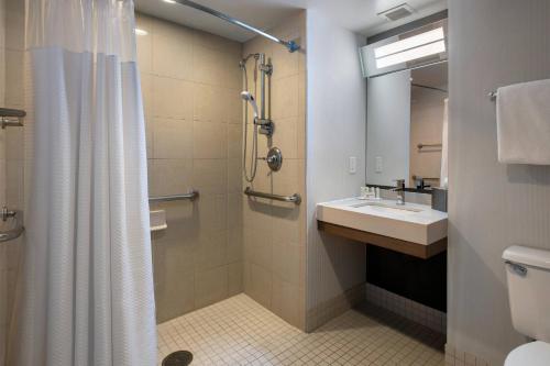 a bathroom with a shower and a sink and a toilet at Courtyard Newburgh Stewart Airport in Newburgh