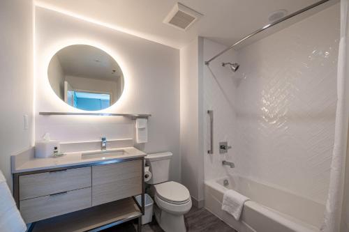 a bathroom with a sink and a toilet and a mirror at TownePlace Suites by Marriott Las Vegas North I-15 in Las Vegas