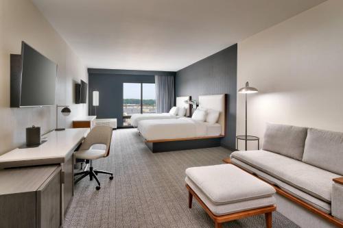 a hotel room with a bed and a desk at Courtyard Ames in Ames