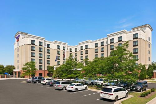 a large building with cars parked in a parking lot at SpringHill Suites Dulles Airport in Sterling