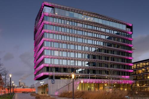 a tall building with purple lights on it at Residence Inn by Marriott Amsterdam Houthavens in Amsterdam
