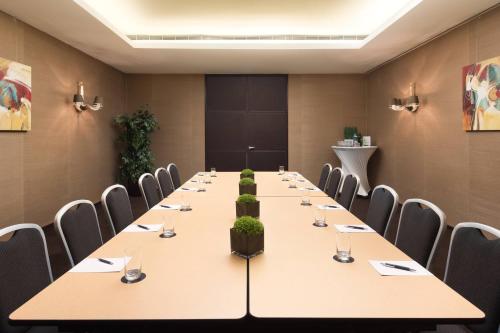 a conference room with a long table and chairs at Sheraton Lisboa Hotel & Spa in Lisbon