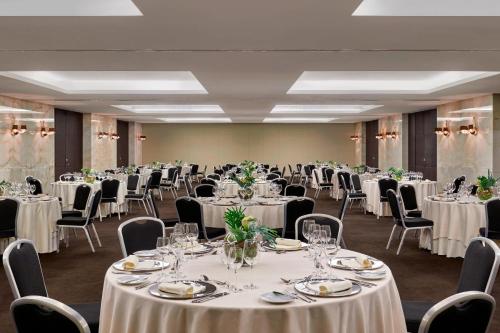 a banquet room with tables and chairs with white linens at Sheraton Lisboa Hotel & Spa in Lisbon