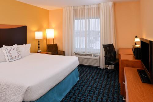 a hotel room with a large bed and a window at Fairfield Inn and Suites by Marriott Fort Wayne in Fort Wayne