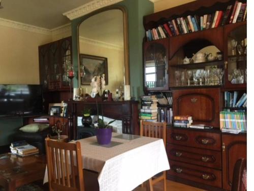 uma sala de jantar com uma mesa e um espelho grande em The Clady em Bunbeg